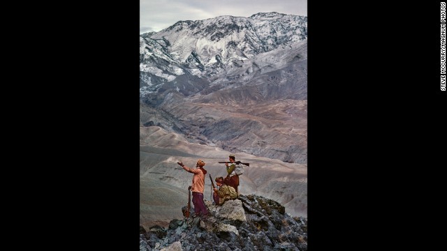 Mujahedeen stand atop a mountain in the Hindu Kush, 1984. 