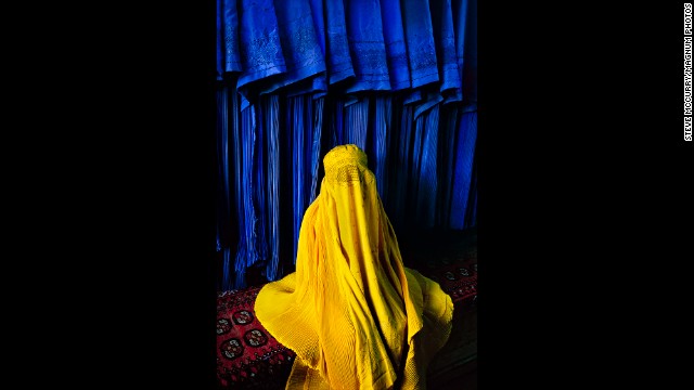 An Afghan woman wears a canary burqa in Kabul, 2002. 