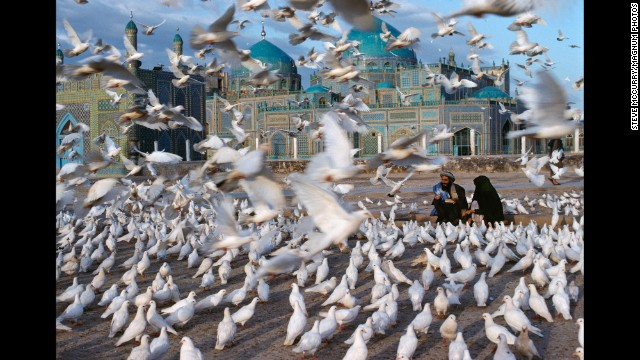 Doves fly in front of the Blue Mosque in Mazar-i-Sharif, 1992. See what inspires iconic photographer Steve McCurry.