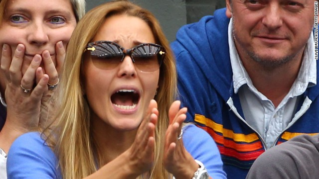 Ristic strikes a typical pose as she supports Djokovic during a match at Wimbledon.