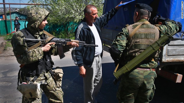 Pro-Russian armed militants inspect a truck near Slavyansk on Friday, April 25. Russian Foreign Minister Sergey Lavrov has accused the West of plotting to control Ukraine and said the pro-Russian insurgents in the southeast would lay down their arms only if the Ukrainian government clears out the Maidan protest camp in the capital, Kiev. 