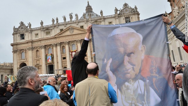 Pilgrims hold up a banner showing Pope John Paul II during the canonization Mass at the Vatican on April 27.