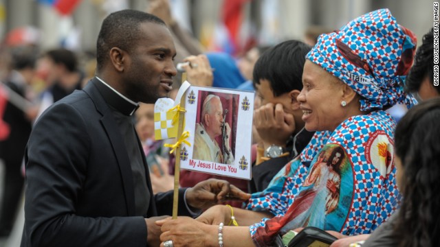 Priests and pilgrims attend the canonization.