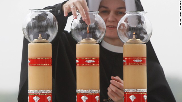 Sister Sancja readies the altar in God's Mercy sanctuary in Krakow, Poland, on April 27, for ceremonies celebrating the canonization of Polish-born Pope John Paul II.