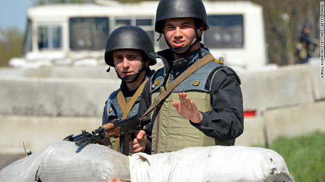 Ukrainian troops stand guard behind a barricade made of sandbags at a checkpoint about 30 kilometers (20 miles) from Slavyansk on April 27.