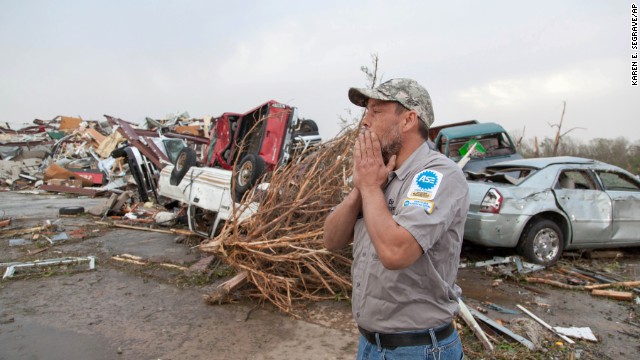 John Smith reacts after seeing what's left of his auto repair shop in Mayflower, Arkansas, on April 28.