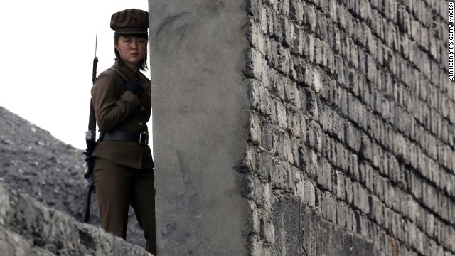 A North Korean soldier patrols the bank of the Yalu River, which separates the North Korean town of Sinuiju from the Chinese border town of Dandong, on Saturday, April 26. A recent United Nations report described a brutal North Korean state "that does not have any parallel in the contemporary world."