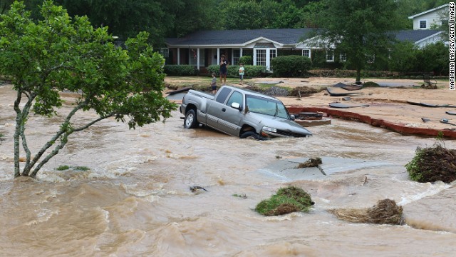 A truck is stuck in the middle of a flooded street after heavy rains in Pensacola on April 30.