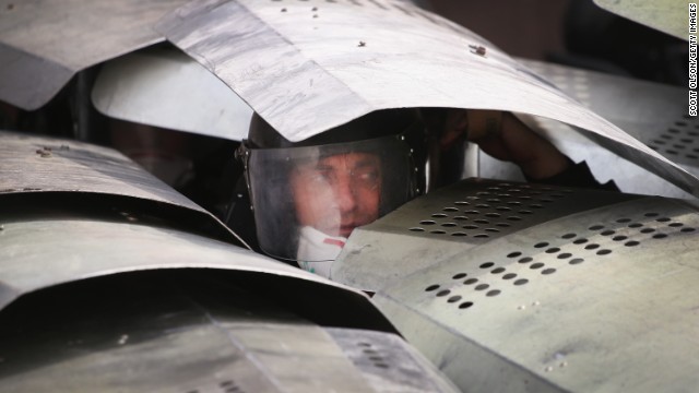 Police take cover under shields as pro-Russian activists storm the prosecutor's office in Donetsk on Thursday, May 1. Eastern Ukraine was a heartland of support for President Viktor Yanukovych, who was ousted in February.