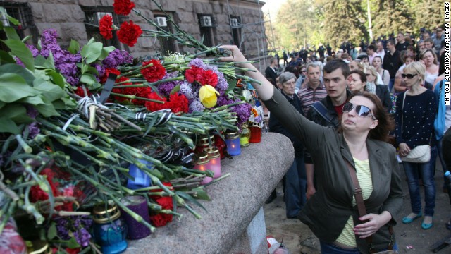 People lay flowers and candles at the burned trade union building in Odessa on May 3.