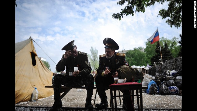 Pro-Russian Cossacks sit outside the regional administration building in Donetsk on May 5.