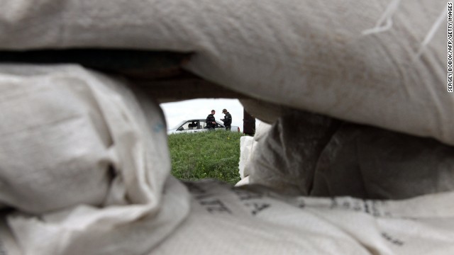 Ukrainian policemen check documents at a checkpoint near the northeastern city of Izium, Ukraine, on May 5.