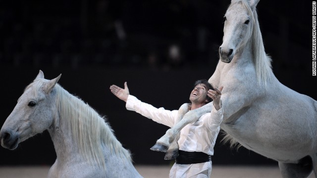 French horse trainer Jean Francois Pignon performs with horses at the opening ceremony for the FEI World Cup jumping and dressage finals in Chassieu, France.