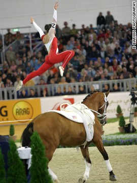 Benjamin performs a split leap. Vaulting's trickiest move may be the shoot-up mount, where the vaulter springs onto the horse while facing its tail, using a combined backflip and reverse-handstand motion.