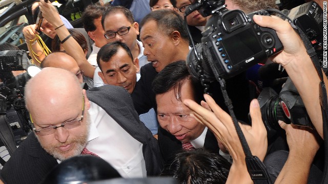 Thomas Kwok (C) is surrounded by the media and security as he arrives at court in Hong Kong on October 12, 2012.