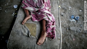 A drug user rests beneath an overpass in a Rio shantytown.