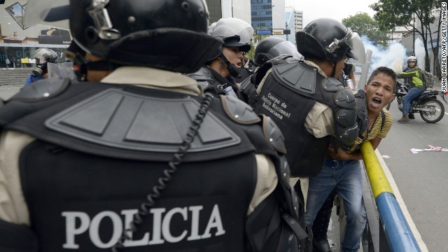 Venezuelan riot police arrest a student taking part in an anti-government protest in Caracas on May 8.