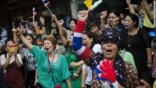 Anti-government supporters celebrate news of the dismissal of then prime minister Yingluck Shinawatra from office Wednesday.