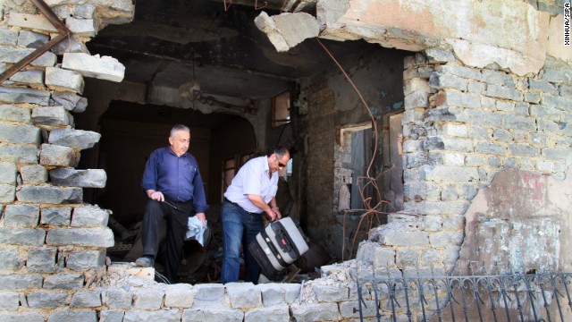 Residents return to damaged dwellings in Homs on May 10. 