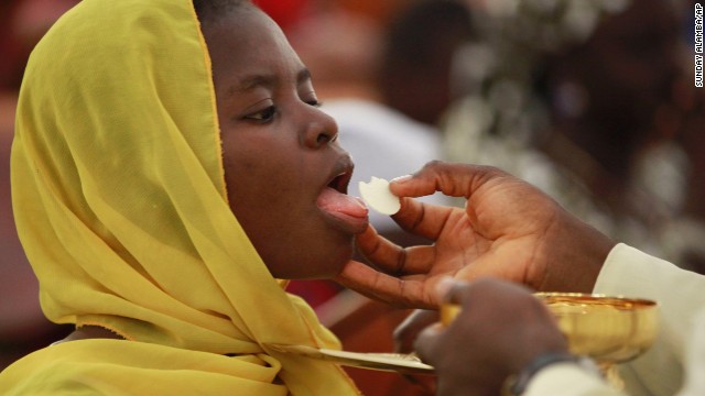 Catholic faithful take Holy Communion and pray for the safety of the kidnapped schoolgirls in a morning Mass in their honor in Abuja, Nigeria's capital, on Sunday, May 11.