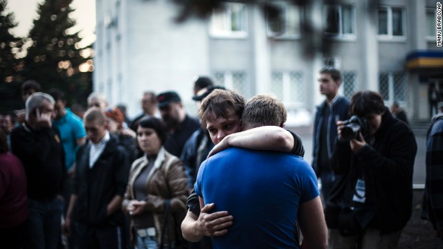 Two men react after Ukrainian national guardsmen open fire on a crowd outside a town hall in Krasnoarmiysk, Ukraine, on May 11.