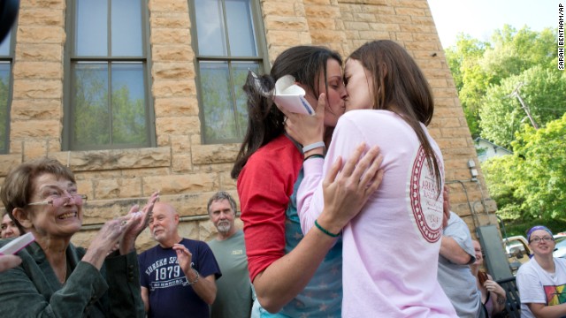 Jennifer Rambo, right, kisses her partner, Kristin Seaton, after their marriage ceremony in front of the Carroll County Courthouse in Eureka Springs, Arkansas, on Saturday, May 10. Rambo and Seaton were the first same-sex couple to be granted a marriage license in Eureka Springs after a judge overturned Amendment 83, which banned same-sex marriage in Arkansas. 