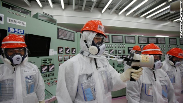 Staff measure radiation levels in the reactors' central control room at the crippled Fukushima Daiichi power plant in March.