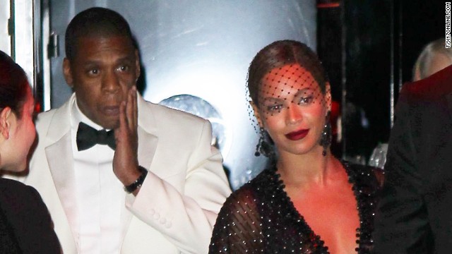 Jay Z touches his face as he leaves the Standard Hotel with his wife, Beyonce. Earlier surveillance footage from a hotel elevator showed what appeared to be Jay Z's sister-in-law first lunging at him, then swinging and kicking him, while a woman resembling Beyonce stood quietly to the side.