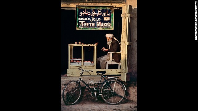 An Afghan teeth-maker sits in a makeshift shop in Kandahar, 1998.