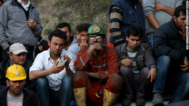 Miners and relatives wait outside the mine. Turkish Energy Minister Taner Yildiz said officials turned an exit pipe "into a clean air pipe," so "there is fresh air being given in places where there is no fire."