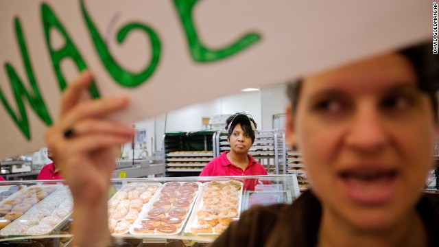 Krispy Kreme employee Beverly Ford looks on as demonstrators enter the store during a protest in Atlanta on Thursday, May 15. Calling for higher pay and the right to form a union without retaliation, fast-food chain workers around the globe participated in a strike.