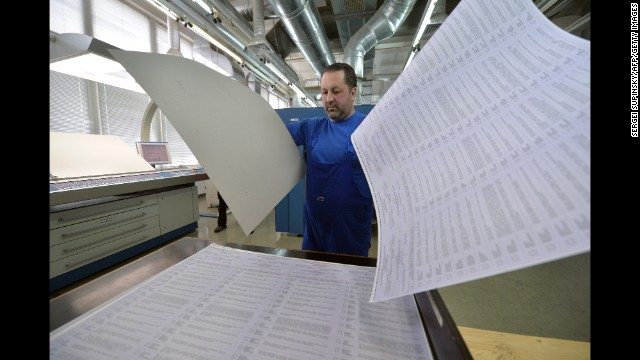 A man examines ballots at a printing house in Kiev, Ukraine, on Wednesday, May 14. The ballots will be used in early presidential voting on May 25.