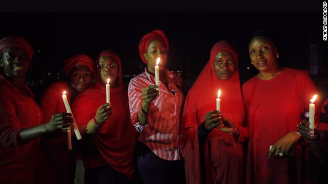 Women in Abuja, Nigeria, hold a candlelight vigil on Wednesday, May 14, one month after nearly 300 schoolgirls were kidnapped by the Islamist militant group Boko Haram. The abductions have attracted national and international outrage.