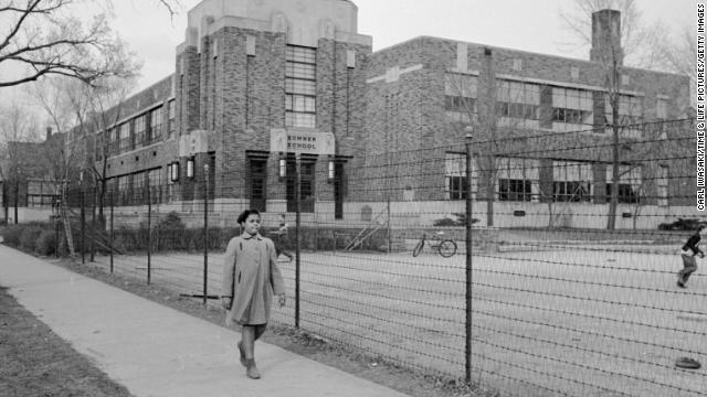 Linda Brown, 9, walks past Sumner Elementary School in Topeka, Kansas, in 1953. Her enrollment in the all-white school was blocked, leading her family to bring a lawsuit against the Topeka Board of Education. Four similar cases were combined with the Brown complaint and presented to the U.S. Supreme Court as <a href='http://www.cnn.com/2013/07/04/us/brown-v-board-of-education/index.html'>Brown v. Board of Education</a>. The court's landmark ruling on the case on May 17, 1954, led to the desegregation of the U.S. education system.