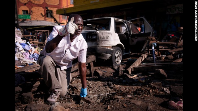 A member of a bomb squad measures the distance between the two blast sites in Nairobi on May 16. The explosions came the day after the United States, Australia and the United Kingdom issued travel alerts for Kenya.