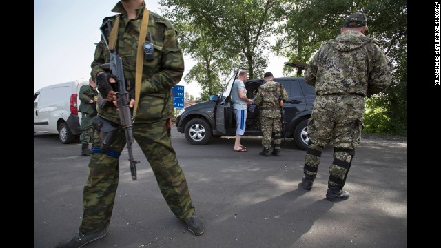 Pro-Russia armed militants guard a checkpoint in Slovyansk, Ukraine, on Monday, May 19, blocking a major highway to Kharkiv. Tensions remain high across the country's east, where pro-Russia separatists staged a referendum on independence on May 11 and presidential elections are set for May 25.