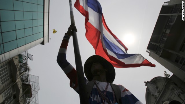 An anti-government protester waves a Thai national flag during a march through streets of Bangkok on Monday, May 19. Martial law went into effect at 3 a.m. the next morning.