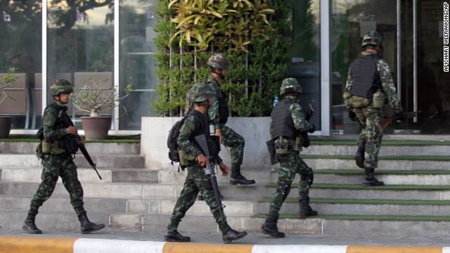 Thai soldiers walk into the National Broadcasting Services of Thailand building on May 20. All Thai TV stations were being guarded by the military.