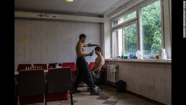 A new recruit gets his hair cut at a training camp for the Donbass Battalion, a pro-Ukrainian militia, in the Dnipropetrovsk region of Ukraine on May 19.