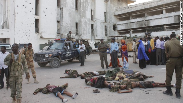 People gather around the bodies of combatants after the attack. 