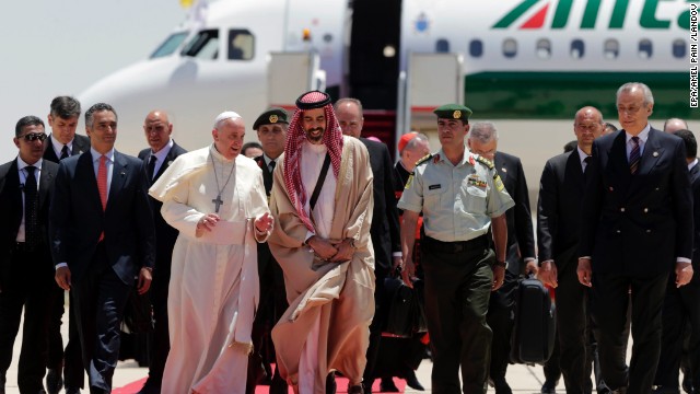 Pope Francis walks with Jordanian Prince Ghazi, chief adviser to the King of Jordan for Religious and Cultural Affairs, on May 24 as he arrives at the Amman airport.