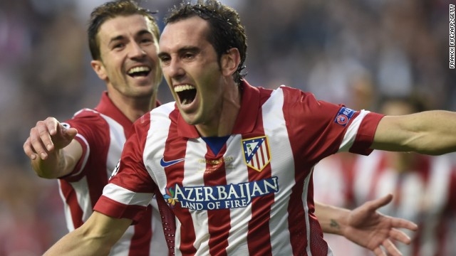 Atletico's Diego Godin puts his side 1-0 up over Real Madrid during their match in Lisbon.