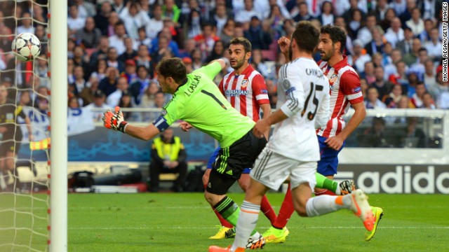 Casillas makes a desperate attempt to keep out Godin's header as his side fell behind in the Champions League final. 