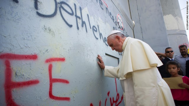 Francis touches the wall that divides Israel from the West Bank, on his way to celebrate a Mass in Bethlehem on May 25.