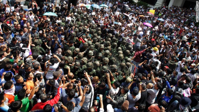 Thai soldiers are surrounded by anti-coup protesters on May 25 during a demonstration in Bangkok.