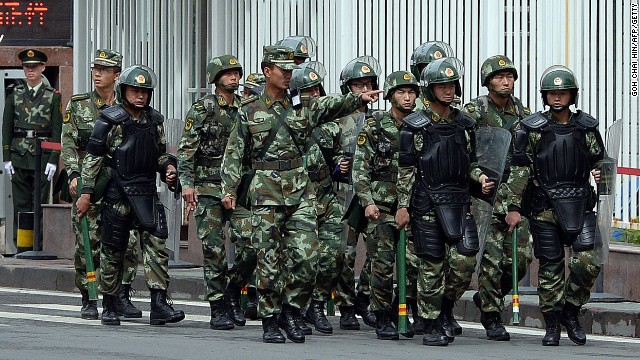 Fully armed Chinese paramilitary police patrol a street in Urumqi, Xinjiang.