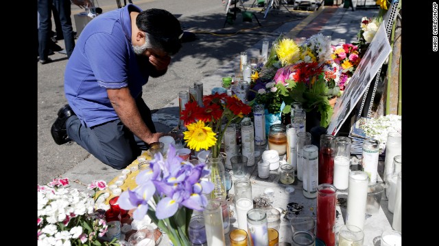 Jose Cardoso pays his respects Sunday, May 25, at a makeshift memorial at the IV Deli Mart, where part of a mass shooting took place, in Isla Vista, California. Rodger also injured 13 others and died of an apparent self-inflicted gunshot wound, authorities said.<br><br>8<br><br>12<br><br>Deadly rampage in California college town<br><br>