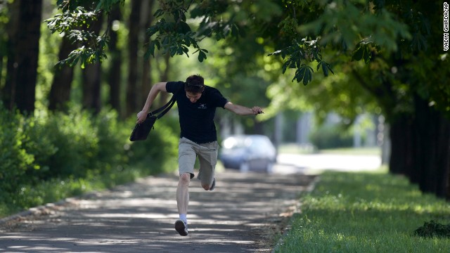 A man runs for cover during fighting around the airport on May 26. 