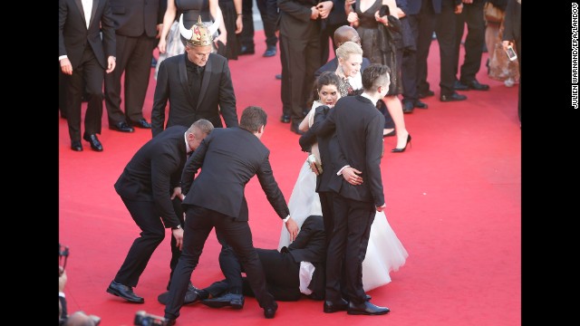 Security guards quickly pull Sediuk away from under the dress of actress America Ferrera on the red carpet at the 2014 Cannes Film Festival in France on May 16.