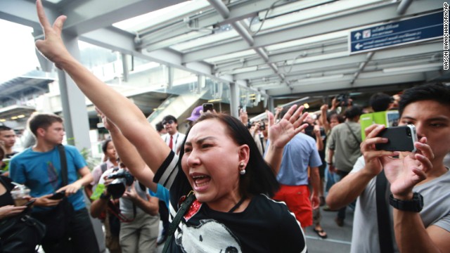 Protesters flash the three-finger salute while shouting during an anti-coup demonstration in Bangkok on Sunday, June 1.